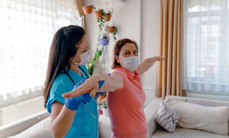 Senior adult, female patient does arm exercises